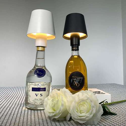 wireless bottle lamp with white and black shade as table decor