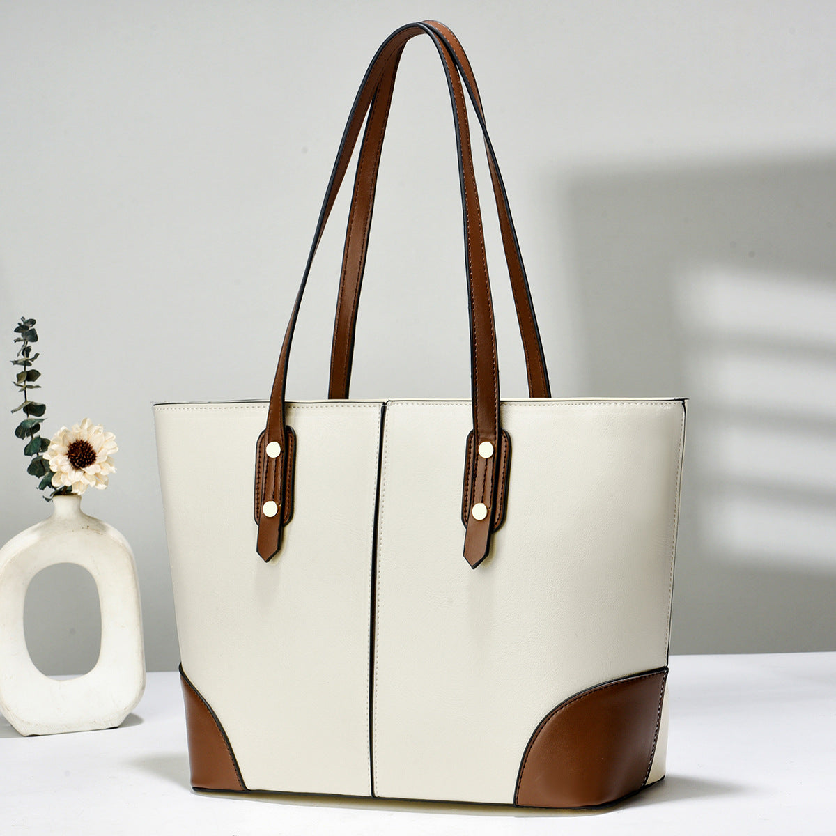 white and brown large women's tote bag, front view, with long shoulder straps