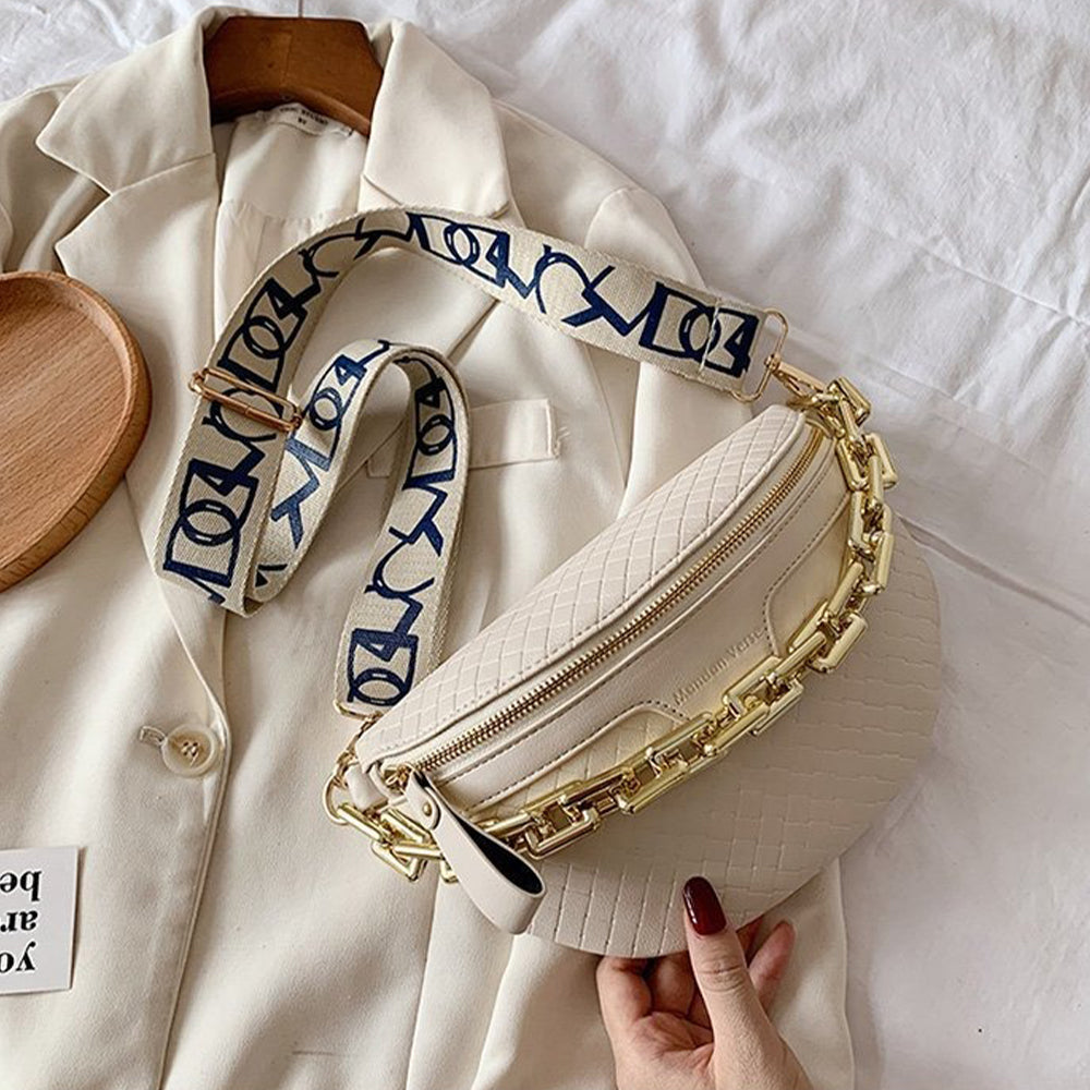 white women's belt bag on a textile background with a gold chain and patterned shoulder strap